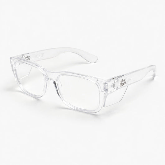 Trade Shades clear frame clear lens safety glasses — three-quarter view showing side shields and Trade Shades branding