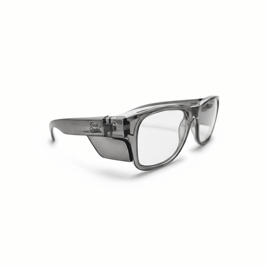 Trade Shades gun grey frame photochromic safety glasses — three-quarter angle view in clear state